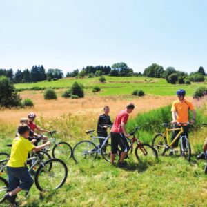 Groupe d’enfants en balade à vélo dans la campagne en été